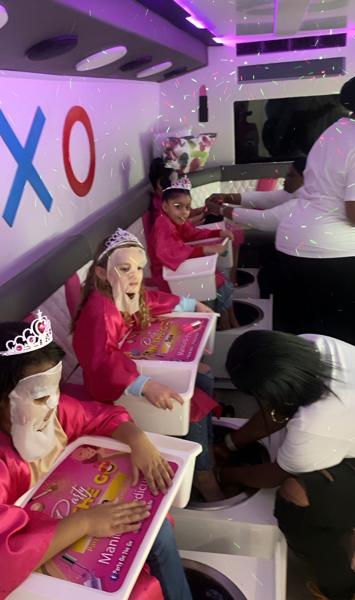 kids-spa-party kids party bus rental Children enjoying a mobile spa party with manicures in a party bus.