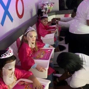 kids party bus rental Children enjoying a mobile spa party with manicures in a party bus.